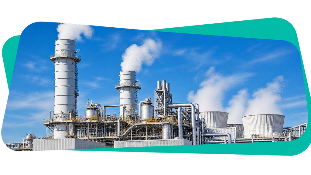 Industrial facility with large chimneys and cooling towers emitting steam under a clear blue sky.