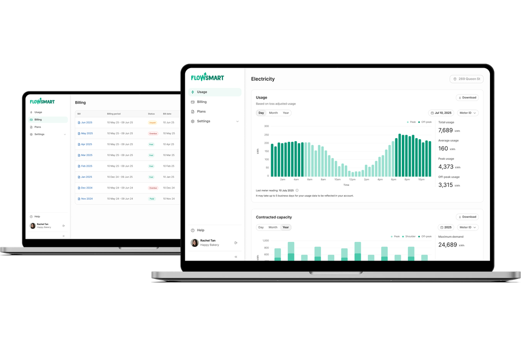 Two laptops displaying FlowSmart software with graphs and data on electricity usage and billing information.